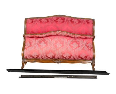 A carved French style double bedstead, labeled Seventh Heaven Bed Specialist. With red upholstery, circa H101cm x W149cm. Met