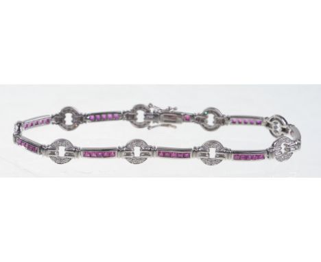 An 18ct white gold ruby and diamond set Art Deco style line bracelet
With alternating circular diamonds set links interspaced
