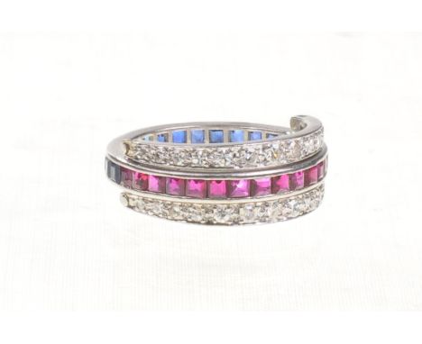 An Art Deco sapphire, ruby and diamond set night and day ring
The full eternity band half set with calibre cut rubies and hal