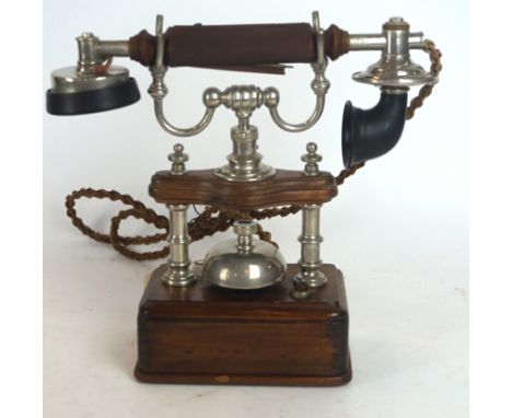 An Ericsson silver metal and hardwood vintage telephone
Having chrome mounts, height 25cm.  CONDITION REPORT: Lot 81: Speaker