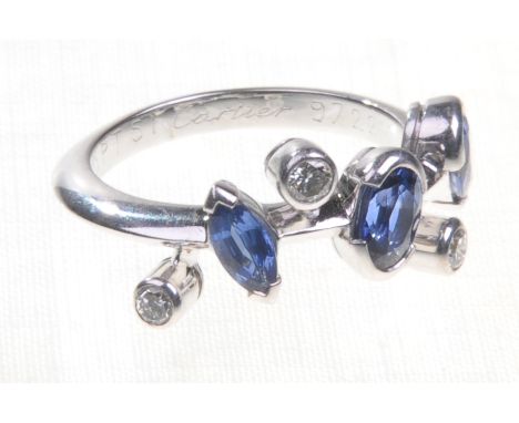 Cartier: a sapphire and diamond set platinum ring
The pear, oval and marquise cut sapphires colette set with scattered round 