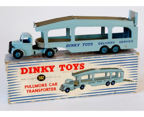 A Dinky no.582 Pullmore car transporter
Light blue tractor unit, trailer with fawn ramps, mid blue ridged and Supertoy hubs '