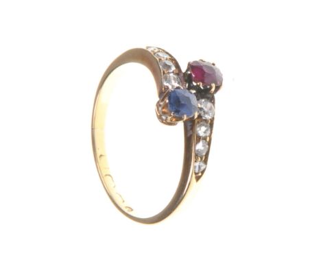 An early 20th Century diamond, ruby and sapphire set dress ring
Set with a oval ruby and oval sapphire to diamond set cross o