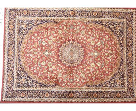 A Keshan carpet on a mainly terracotta ground 
The central single multiple faceted medallion with extensive foliate decoratio