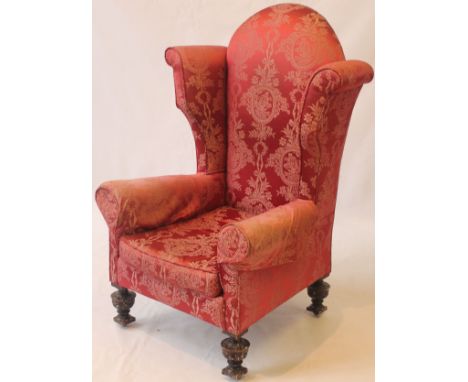 A handsome Georgian-design high wingback gentleman's armchair, 20th Century
Upholstered in a sympathetic foliate and ribbon p