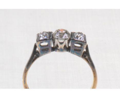 A diamond set three stone ring
The central old round cut diamond claw set to radiant cut diamonds to either side, with taperi