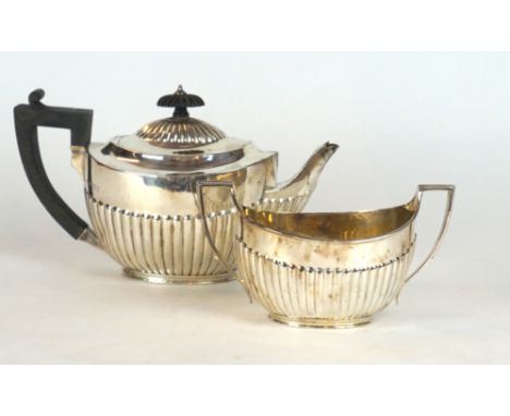 A late Victorian hallmarked silver two piece tea service
Comprising tea pots and twin handled sugar bowl, each having gadroon