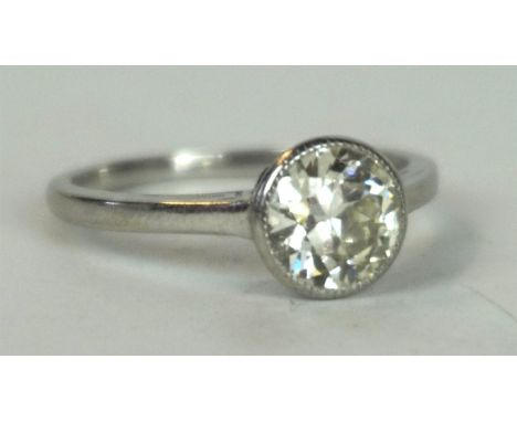 A fine quality diamond single stone ring, circa 1930
The old round cut diamond collet set to decorative shoulders and plain b