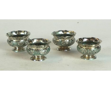 A set of four Victorian hallmarked silver salt cellars
Having wavy rims, having repousse decoration with traces of green enam