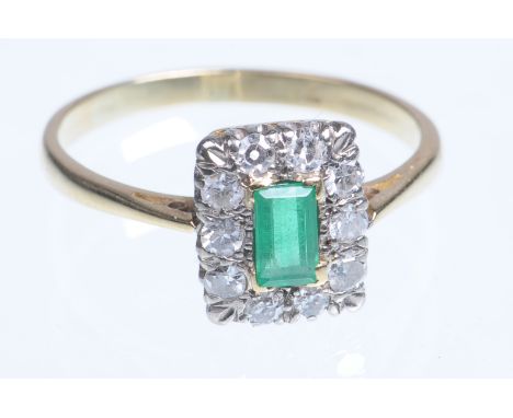 An emerald and diamond set square cluster ring, early 20th Century
The central emerald cut emerald of approx 5x3mm claw set t