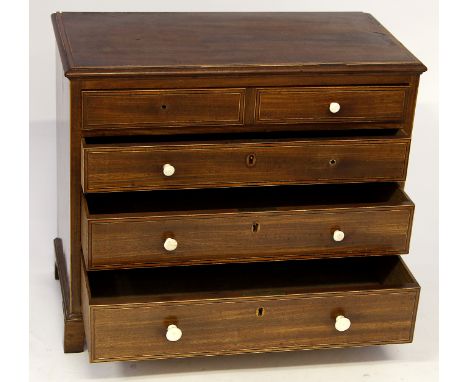 A Victorian mahogany Georgian revival straight front apprentice chest of four drawers
With turned ivory handles, raised on br