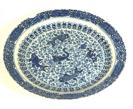 A Chinese blue and white porcelain dish,  Kangxi (1644-1722)
Of circular form, the exterior edge with a scalloped rim, the ce