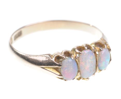 A 15ct gold opal three stone ring
The three oval cabochon opals of good colour to tapering shoulders and plain band, and hall