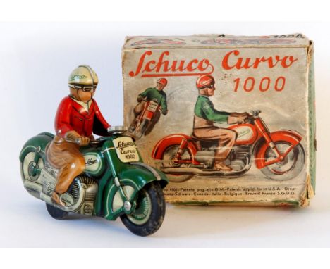 A boxed Schuco Curvo no.1000 tinplate clockwork motorcycle 
Green with cream detail and tin printing, rider has red jacket, c