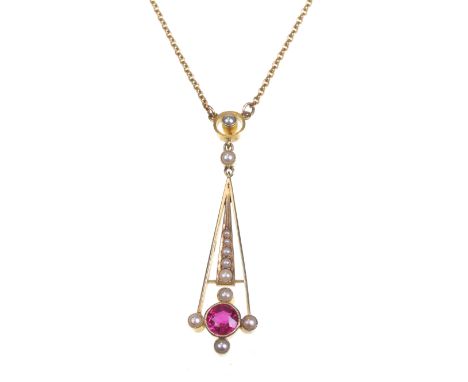 A early 20th century Art Nouveau pendant necklace
The angular open work pendant centrally set with a synthetic ruby with seed