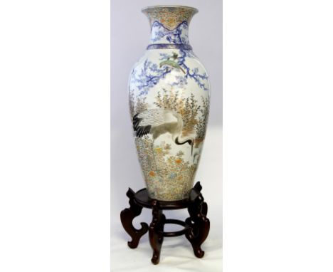 A Large Japanese porcelain vase, early 20th Century 
Of tapered ovoid form, the milky white glazed body, painted with a scene