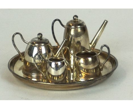 A miniature hallmarked silver tea service and tray
Comprising teapot, hot water pot, twin handled sugar bowl and cream jug, m