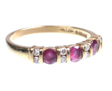 A 18ct gold ruby and diamond set half hoop ring
The three round cut rubies with twin diamond set inter spacers to tapering ba