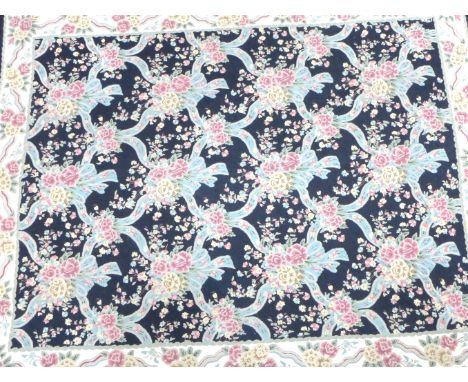 A fine quality tapestry on a mainly black ground 
The central panel with multiple floral decoration flanked by matching borde