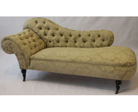 A Victorian chaise lounge
Elegantly and sympathetically re-upholstered in a buttoned foliate woven fabric, raised on four rin