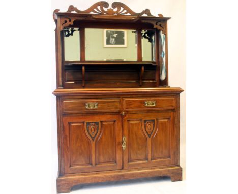 An Edwardian walnut mirror back sideboard 
The upper section featuring a carved and pierced crest above three bevelled mirror