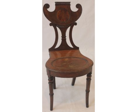 An English Regency period mahogany Hall chair, in the manner of Thomas Hope
The opulent and extravagant shaped back above a d