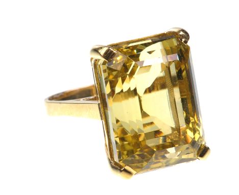 A golden beryl set dress ring
The emerald cut golden heliodor of excellent colour, of approx 30cts, four claw set to raised g