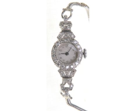 A diamond set cocktail watch, circa 1940
The cream Arabic dial, within diamond set bezel, two diamond set lugs and pierced de