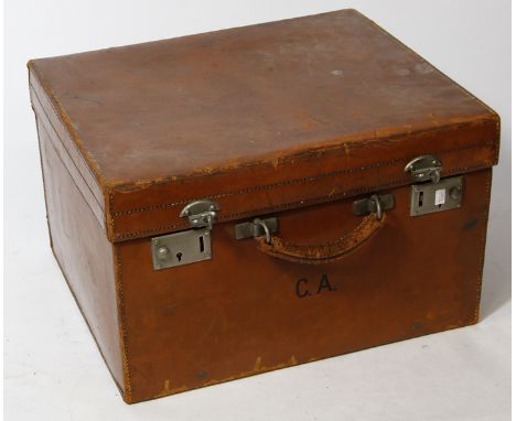A late 19th Century brown leather storage trunk
Of square proportions, with printed initials C.A., the hinged cover lifts to 