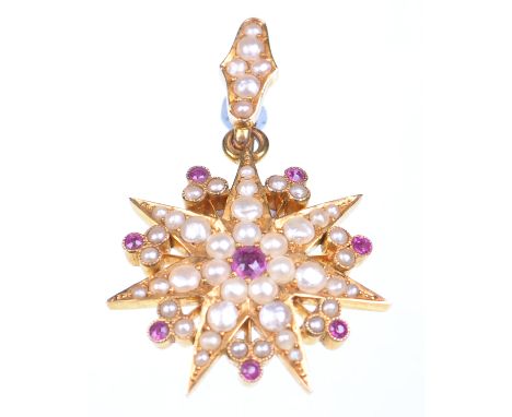 An early 20th Century ruby and split pearl set pendant
Of star form set with a central round cut ruby to split pearl set radi