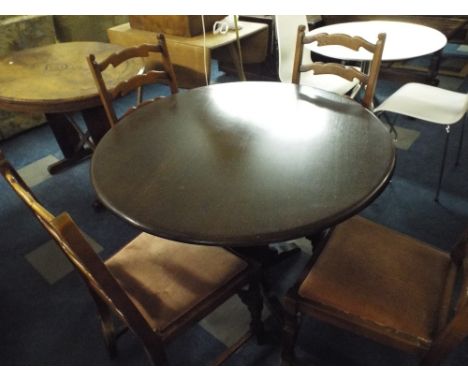 An Oak Circular Topped Table with Four Ladder Back Chairs. 