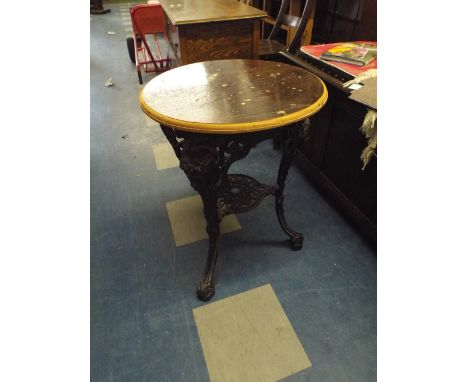 A Circular Topped Pub Table on Cast Iron Tripod Base with Claw and Ball Feet.