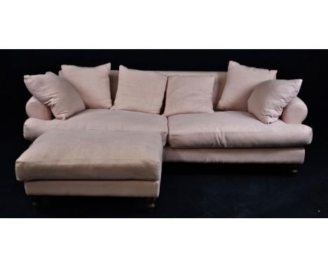 A pink upholstered sofa.com three-seater sofa and matching footstool. H.80 W.250 D.110cm. 