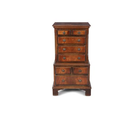 A MODERN MAHOGANY RECTANGULAR COMPACT CHEST, in two stages fitted two short and three long drawers with ring handles, above t