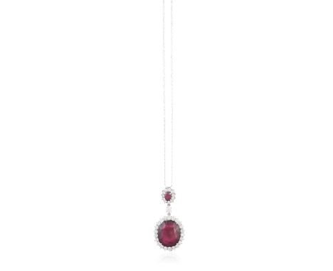 A RUBY AND DIAMOND PENDANT ON CHAIN, the large cushion-shaped ruby weighing approximately 28cts, within a surround of round b