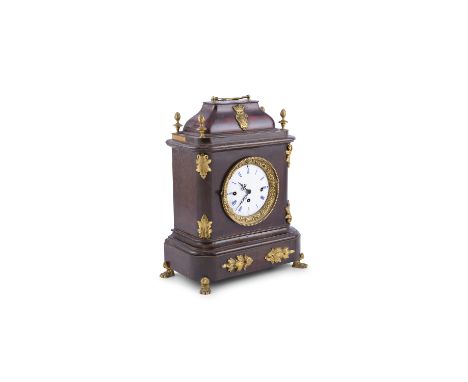 A MANTLE CLOCK, 19TH CENTURY, the arched domed top, surmounted with swing bracket handle and applied a coat of arms, with whi