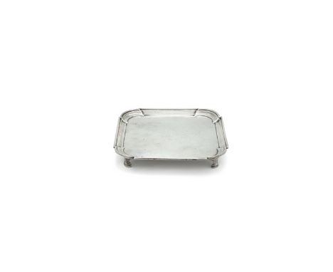 A SILVER CARD TRAY, London c.1725, maker's mark of John Tuite, of shaped rectangular form, with cavetto rim, raised on four b