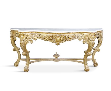 A 19TH CENTURY CARVED GILTWOOD AND GESSO CONSOLE TABLE, the white marble top of serpentine form, raised above a pierced friez