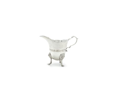 A GEORGE II IRISH SILVER HELMET SHAPED CREAM JUG, Dublin c.1750, maker's mark possibly that of Robert Calderwood, of plain de