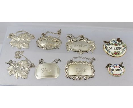 A COLLECTION OF SIX VARIOUS SILVER SPIRIT LABELS, varying designs from a plain Georgian style "Gin" to vine leaf forms, combi