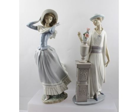 TWO LLADRO PORCELAIN FIGURINES "Ladies of Fashion", one modelled as a young woman in a breeze, the other contemplating a vase