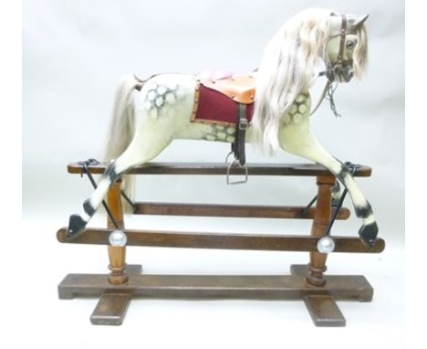 AN EARLY 20TH CENTURY "LINES" DAPPLE GREY ROCKING HORSE, circa 1925, sympathetically restored to include replacement horse ma