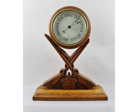 AN EARLY 20TH CENTURY CONTINENTAL DESK OR MANTEL BAROMETER, the circular dial set within a turned wood frame mounted upon car