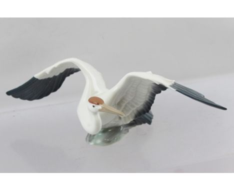 A LATE 20TH CENTURY LLADRO MODEL OF A STORK/HERON, seated with outstretched wings, decorated in white and grey with printed, 