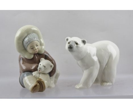 TWO LATE 20TH CENTURY LLADRO MODELS, one a Polar Bear, the other a seated Eskimo Child cuddling a Polar Bear cub, both decora