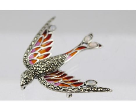 A SILVER, MARCASITE AND OPAL SET BIRD BROOCH fashioned in flight, having coloured translucent decoration, with pin back, stam