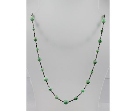 A PERIOD CUT STEEL AND NEPHRITE JADE BEAD NECKLACE with snap clasp, 66cm long 