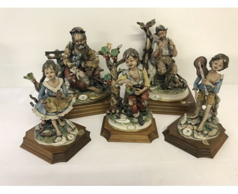 A collection of 5 large Capodimonte Bellinaso ceramic figurines mounted on wooden plinths.  