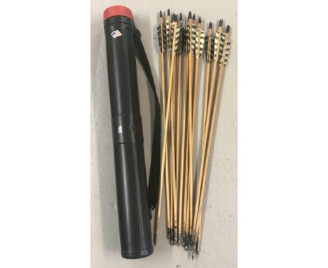 A set of 12 handmade wooden 27" steel-tipped arrows with black and white fletchings.  In a black plastic arrow case with red 