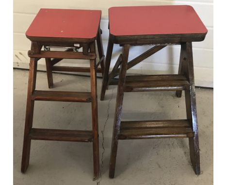 2 vintage wooden folding sets of steps with red melamine tops. Both with chromed carrying handles.  Tallest approx. 75cm when